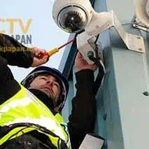 CCTV camera being installed on a building exterior for security purposes in Balikpapan.