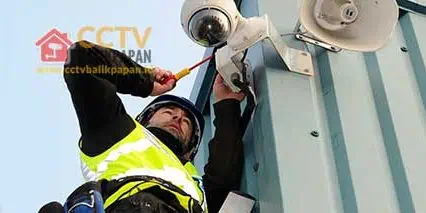 CCTV camera being installed on a building exterior for security purposes in Balikpapan.