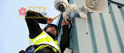 CCTV camera being installed on a building exterior for security purposes in Balikpapan.