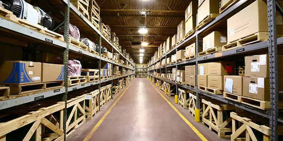Warehouse storage with CCTV cameras for security monitoring. CCTV camera installed in a warehouse for security and inventory management.