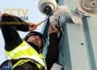CCTV camera being installed on a building exterior for security purposes in Balikpapan.